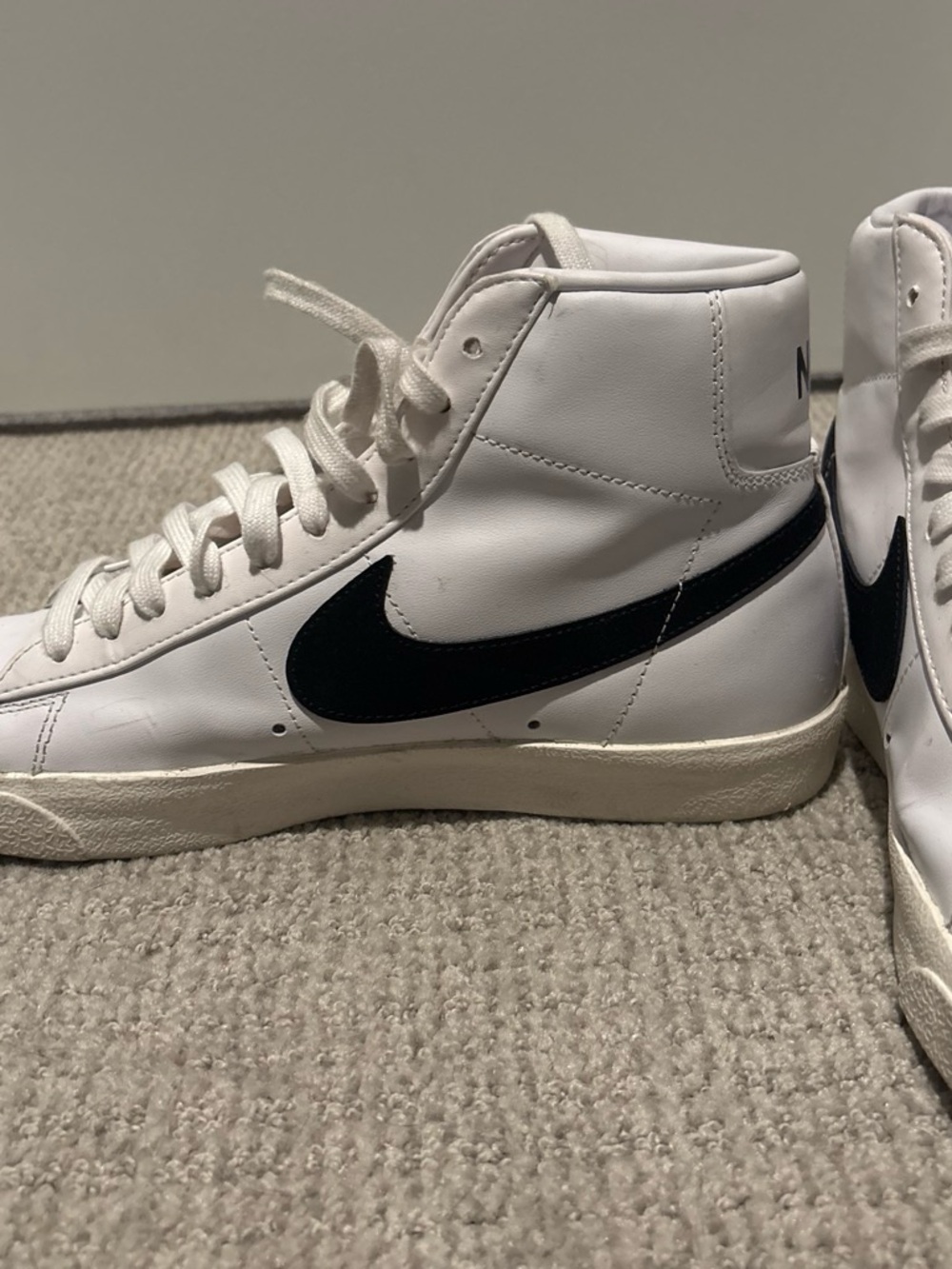 Nike White High-Top Sneakers with Black Swoosh